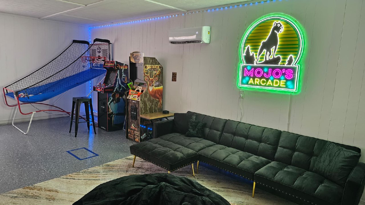 Mojo's Arcade game room glowing neon sign with retro arcade games